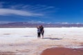 Happy tourists enjoy Jeep tour activities in Salt flats Salar de Uyuni in Bolivia